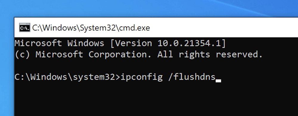 Entering the command to flush the DNS cache within the Windows Command Prompt.